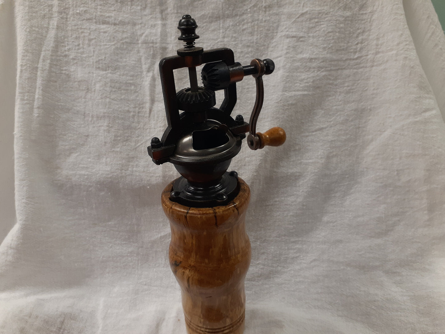 Antique style pepper grinder in antique brass and bird cherry burl