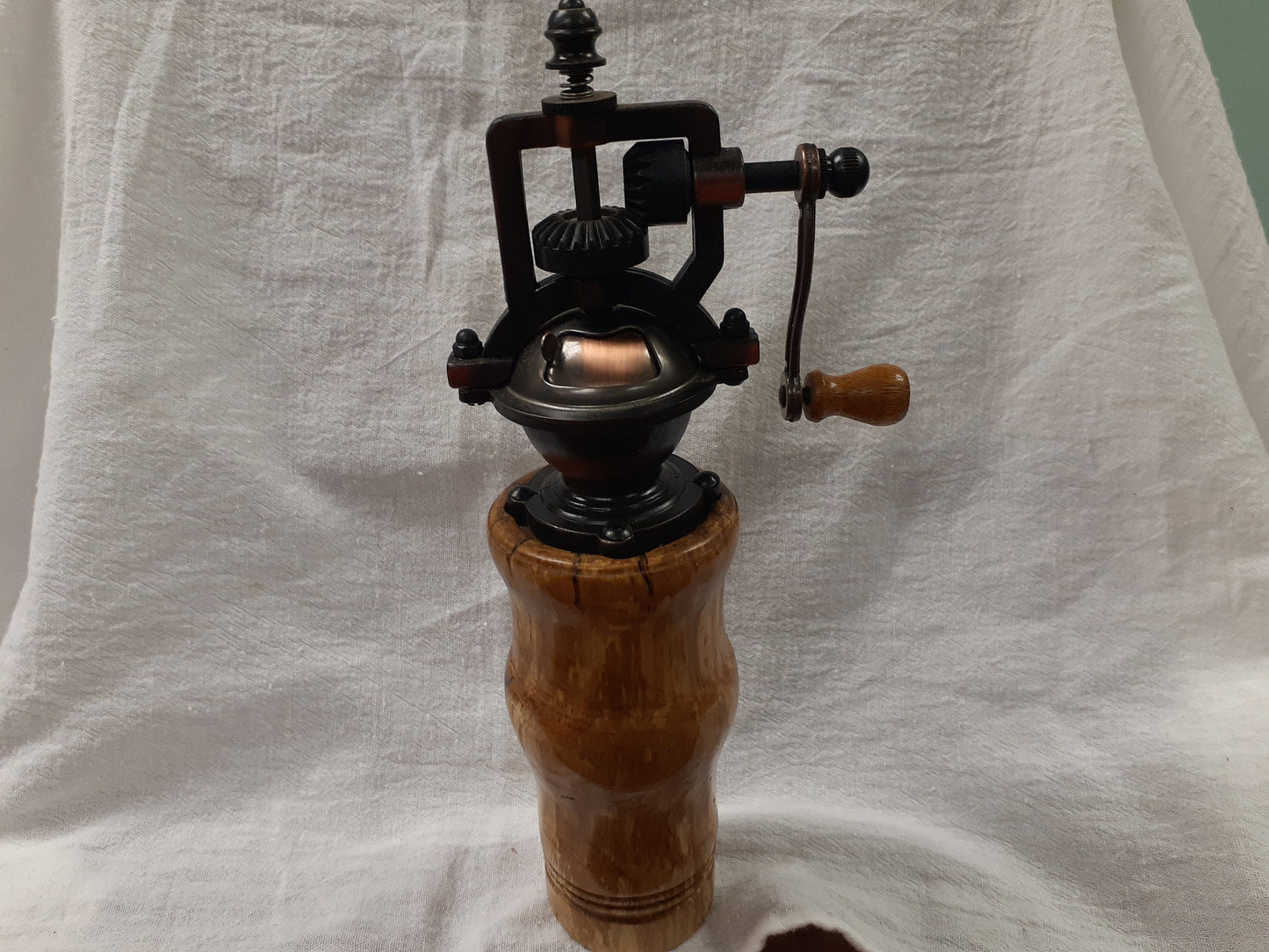 Antique style pepper grinder in antique brass and bird cherry burl