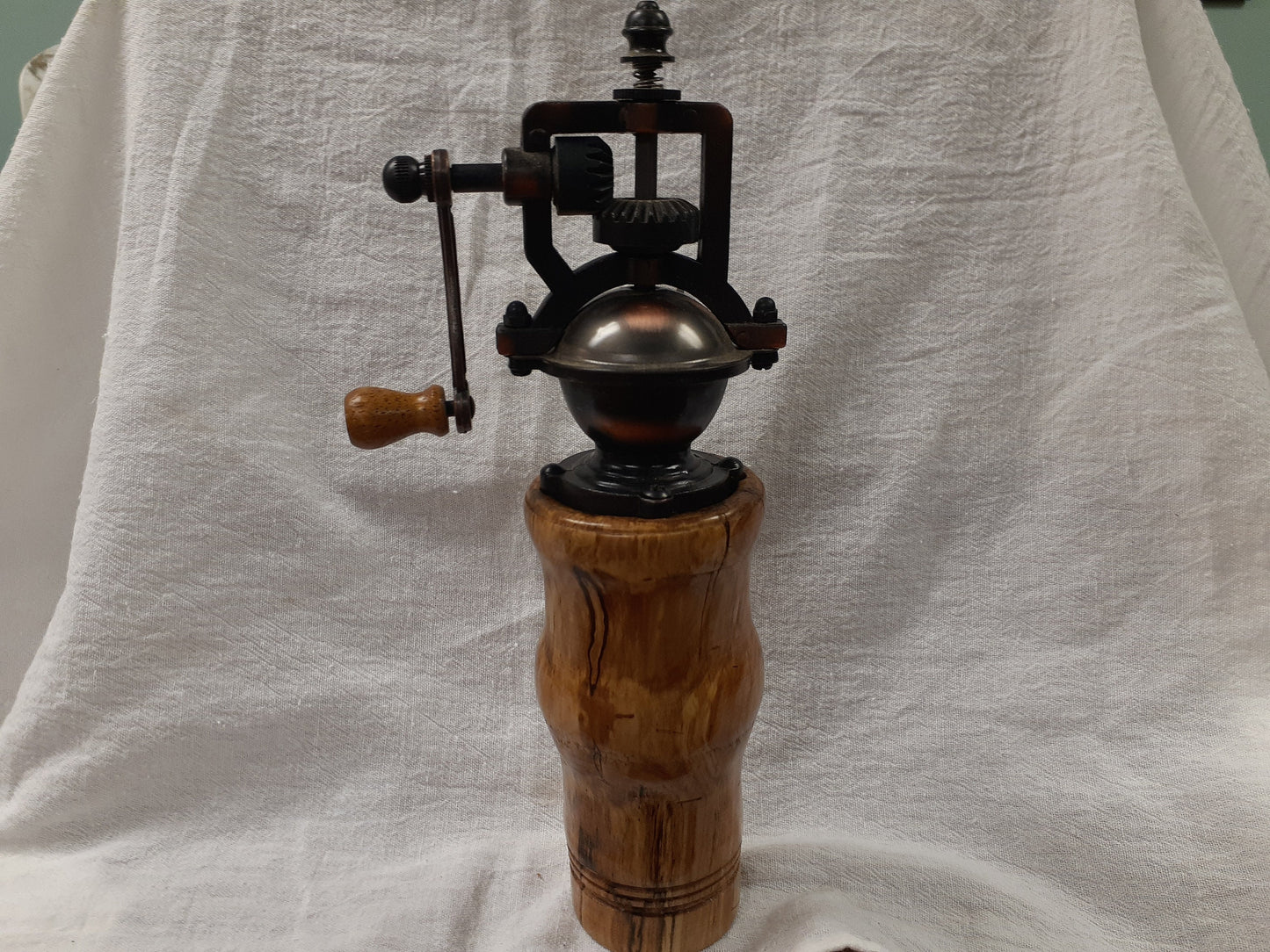 Antique style pepper grinder in antique brass and bird cherry burl