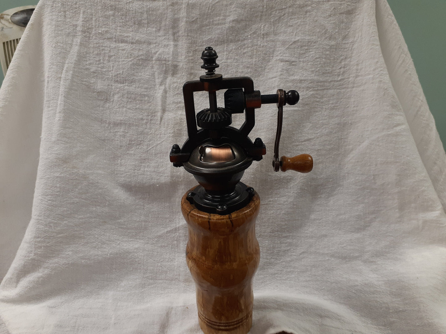 Antique style pepper grinder in antique brass and bird cherry burl